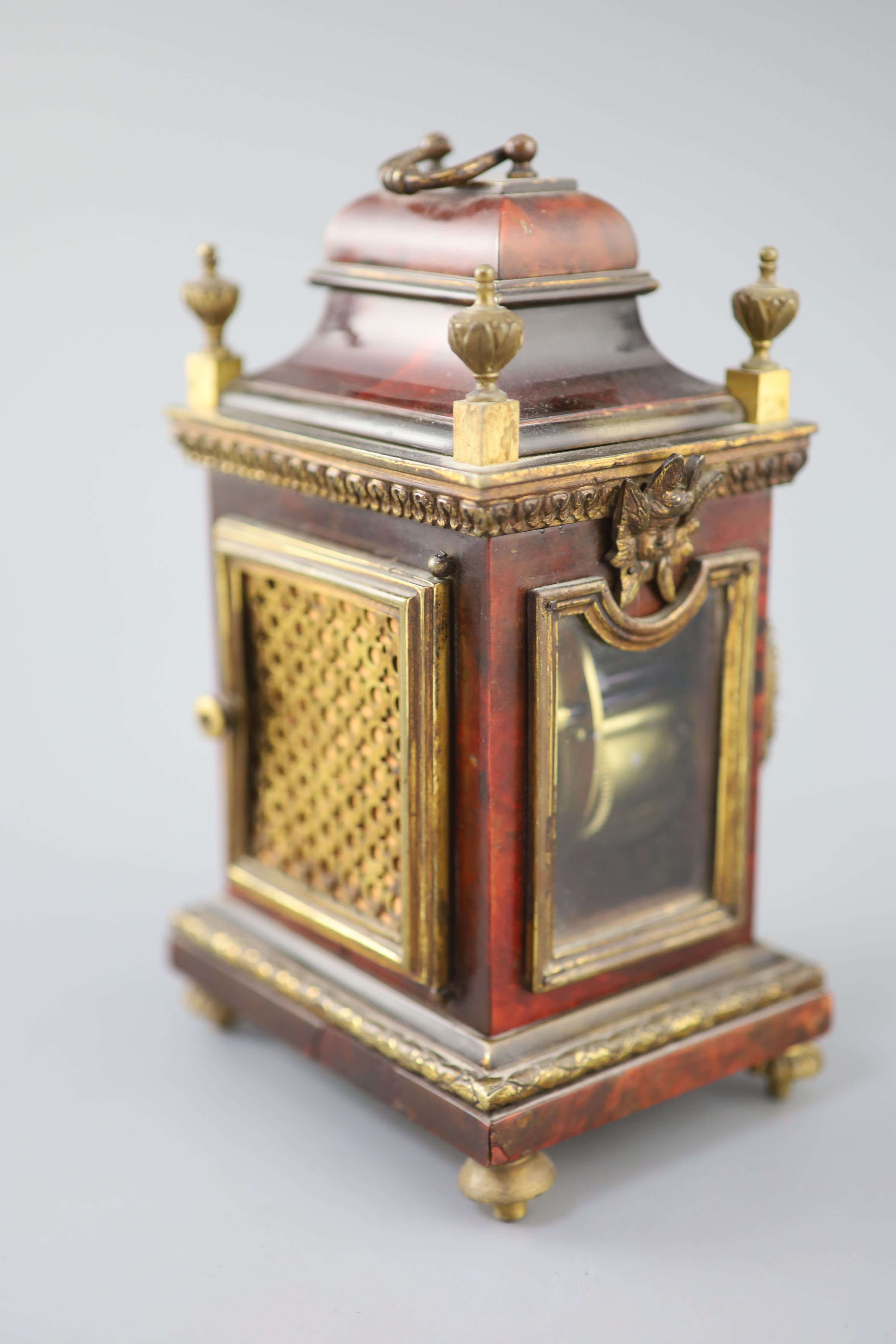 An early 20th century red tortoiseshell veneered mantel timepiece, height 8in.